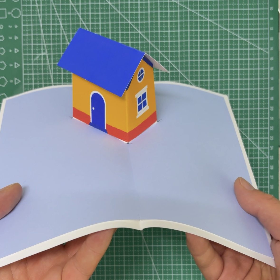 Finished pop-up mini house card standing upright when opened